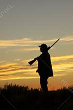 Hunter With Shotgun in Sunset