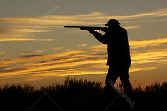 Hunter Shooting in Sunset