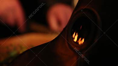 Reflected fireplace light in a mask of a plague doctor.
