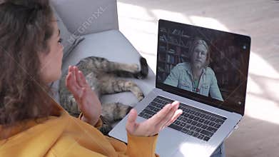 Hispanic girl talking with friend or teacher meet online video call on laptop.