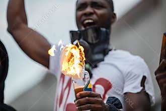 Angry africanamerican man going to throw a fire bottle