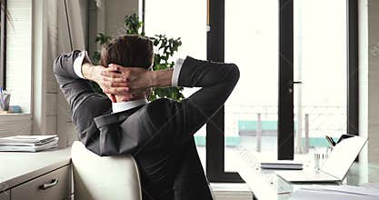 Happy businessman satisfied finished work taking break relaxing at workplace