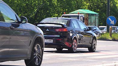 Cars start moving at the intersection. Toyota prius hybrid. Car traffic in the city. Dense urban traffic of cars and buses. Roadsi