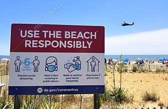 Rehoboth Beach, Delaware, U.S.A - June 13, 2020 - The sign on the boardwalk that advised the visitors to wear mask, sanitize