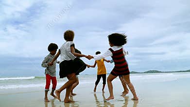 Slow motion video shot of African-American children are dancing and dancing on the beach, in the summer atmosphere.