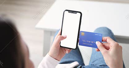 Closeup woman holding smartphone with mockup screen and credit card.