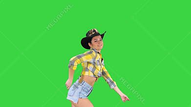 Cowboy girl dances walking on a Green Screen, Chroma Key.