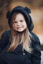 Portrait of beautiful baby goes for a walk in the park in autumn, picture isolated on blur background