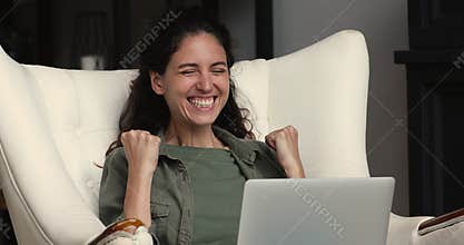 Overjoyed woman read great news on laptop celebrate lottery win