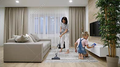 Preteen Daughter and mother cleaning their home`s living room, slow motion
