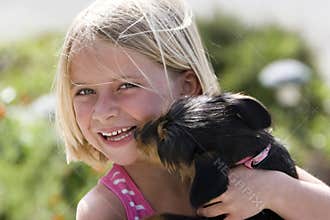 Puppy Licking Girl's Face