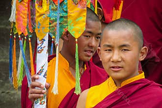 Young Buddhist monk at ceremony of Buddha annivewrsary celebration in Nepal temple