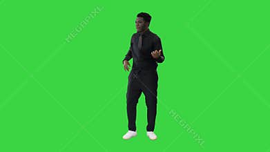 Passionate African American man pretending to play an invisible guitar on a Green Screen, Chroma Key.