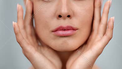 Extreme closeup feminine lips and chin applying anti aging cream on face skin. 4k Dragon RED camera