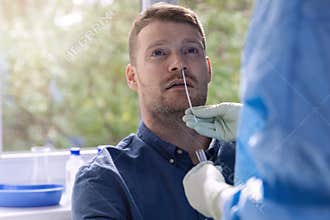 Covid-19 nasal swab test - doctor taking a mucus sample from patient nose