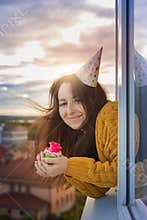 A young girl is celebrating her birthday alone