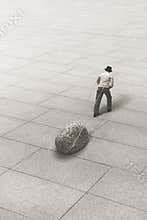 Man carries a giant stone, concept of strength and success