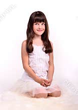 Small girl in angelic costume on white cloud