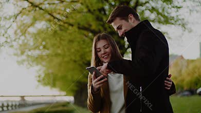 Boyfriend and Girlfriend Watch Photos From Smartphone .