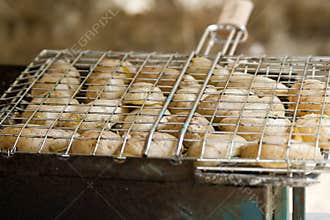 Potatos grilled in gridiron