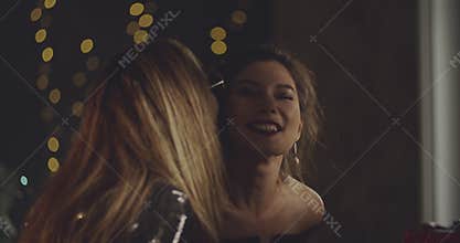 Cheerful young friends presenting gifts to a birtday girl and hugging her. Xmas, friendship, birthday, ny, lifestyle, ad