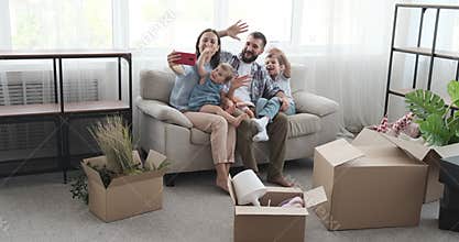Family doing video call using mobile phone in new home
