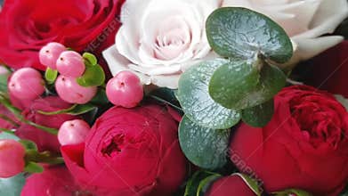 Beautiful bright bouquet with red flowers. Juicy Burgundy roses and pink St. John`s Wort berries in the autumn bouquet. Birthday