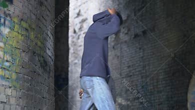 Troubled black male with baseball bat following victim, urban danger, abuse