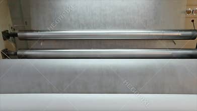 Rolls of non-woven fabric are being pushed into the tube. Nonwoven fabric production