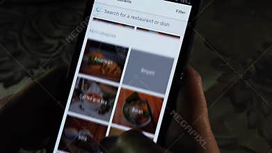 A person scrolling through food option, online food ordering on an app - Uber Eats app