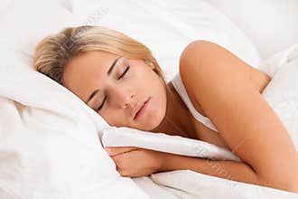Woman sleeping in bed. Recreation and dreams.