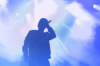 Young hip hop singer on stage in music hall