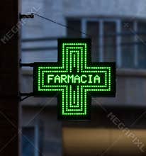 Bologna / Italy - September 22, 2019: European green cross pharmacy store sign: Farmacia, pharmacy sign.