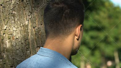 Young man secretly spying his girlfriend meeting with friend, jealousy, betrayal