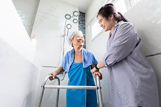 Asian daughter or female care assistant service, help,support senior woman taking a shower in bathroom,take care closely,happy