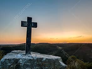 Huge wooden Orthodox eight-pointed cross against the sky after the dawn on Mount Athos