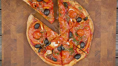 Hands takes slices of vegan pizza from the wooden plate, stop motion animation
