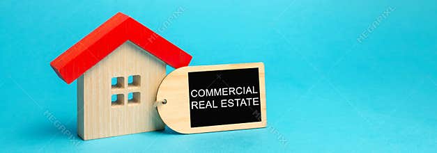 Wooden house with the inscription Commercial Real Estate. Buildings intended to generate a profit, capital gain or rental income.