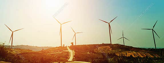 concept idea eco power energy in nature. wind turbine on hill and sunset
