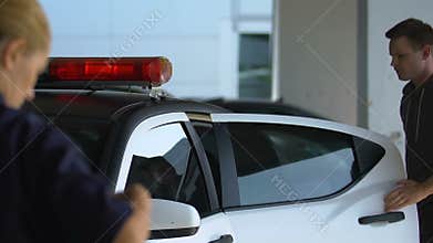 Group of cops arresting male bandit, woman aiming gun at dangerous criminal