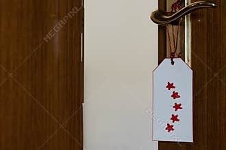 Five-star review on a label hanging in the door. Feedback concept