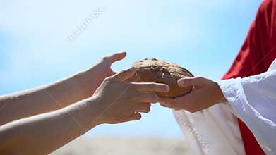 Jesus hands giving bread to poor man, biblical story to feed hungry, charity