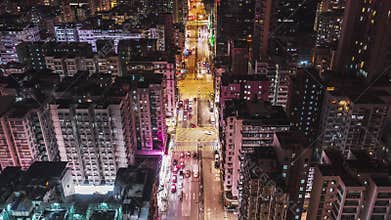 Hyperlapse time-lapse of car traffic and people walking at night in Hong Kong downtown district, drone aerial dolly top view