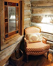 Cozy Chair in a Log Cabin Corner