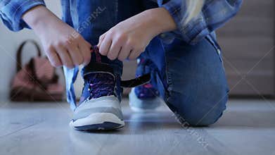 Child tying shoes laces, kid preparing leave house, girl going school, shoelaces