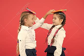 Break is time for fun. Cute small children holding books. Adorable little girls with school exercise books. Preparing