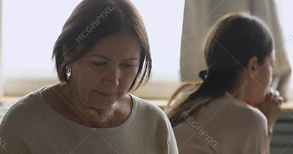 Sad worried older mother feel hurt after fight with daughter