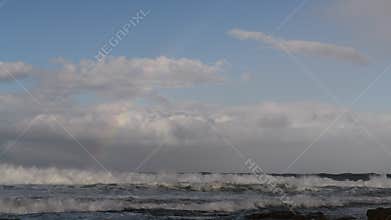 Clouds and rainbow in the sky over the ocean. South Africa. Mossel bay