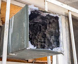 Old air duct filled with dust and dirt