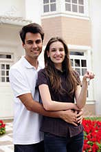 Couple standing outside new house